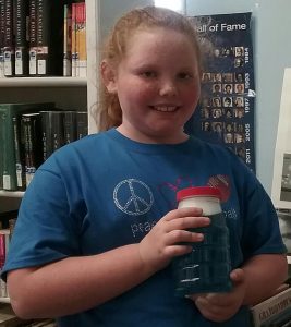 Journi Langley holding her tornado in a jar