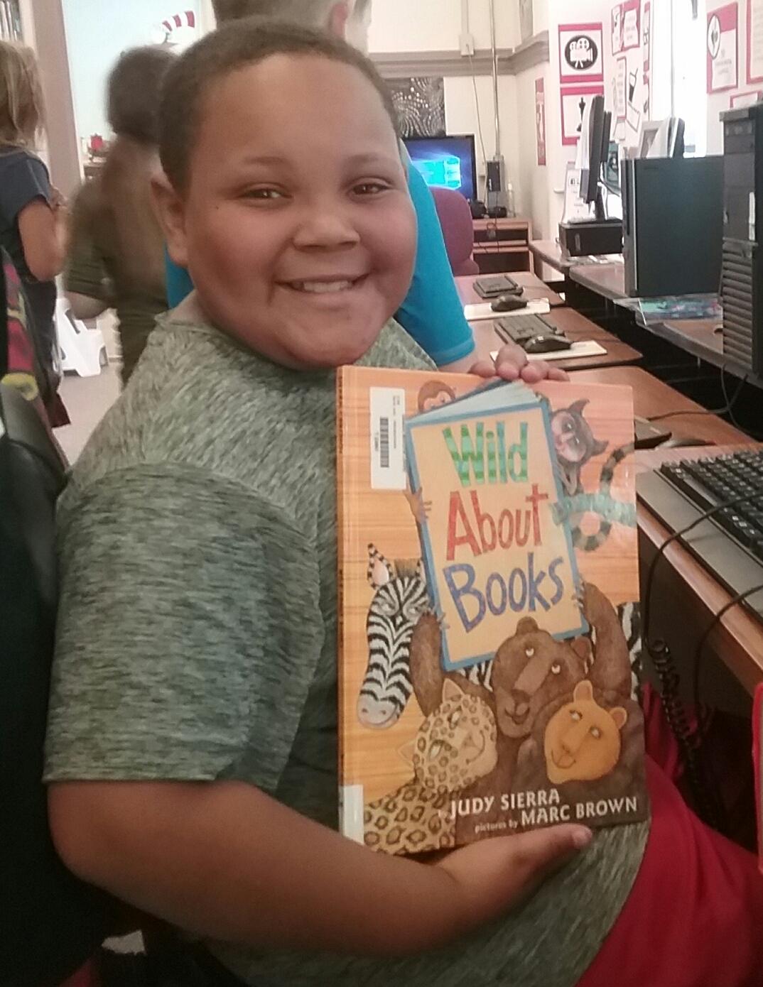 Student showing the book Wild About Books